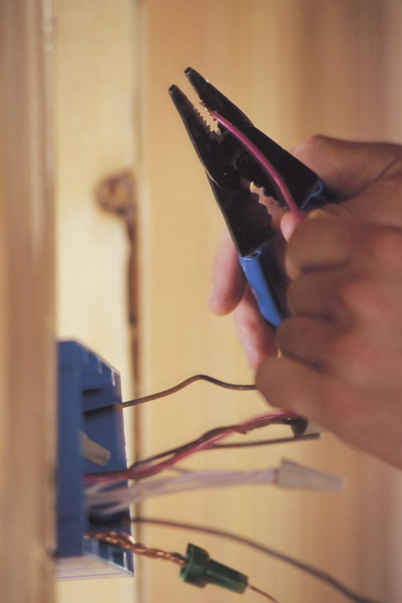 Electrician Cutting A Wire